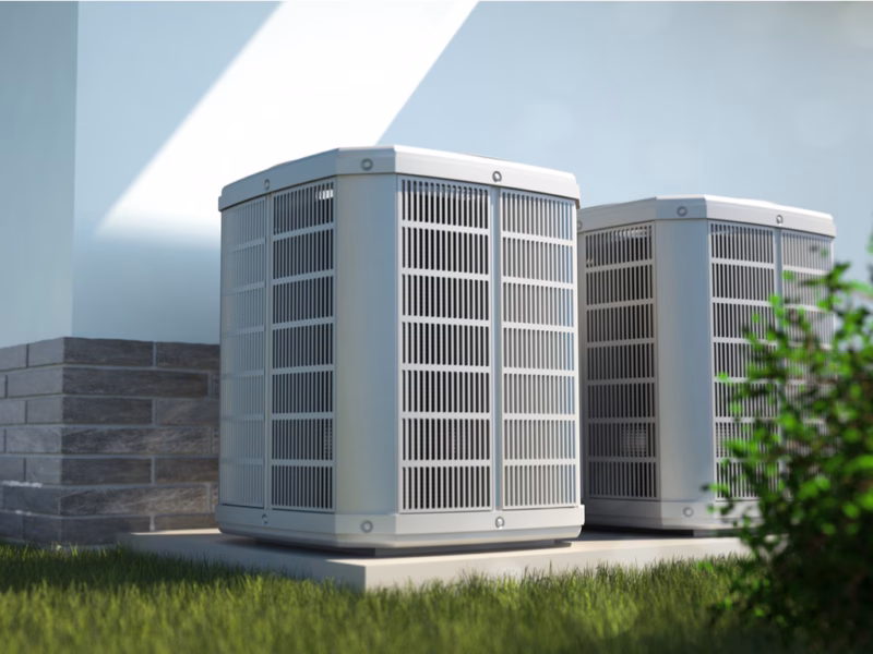 Two air conditioning units outside next to a house in Charlottesville Virginia