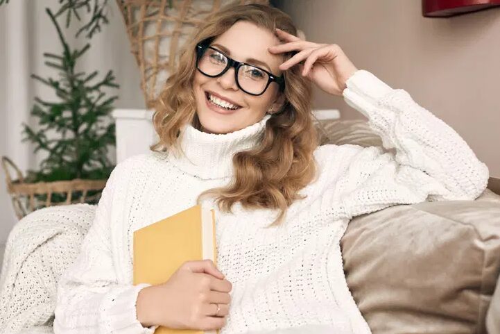 A woman wearing a white sweater inside her warm home in Charlottesville Virginia