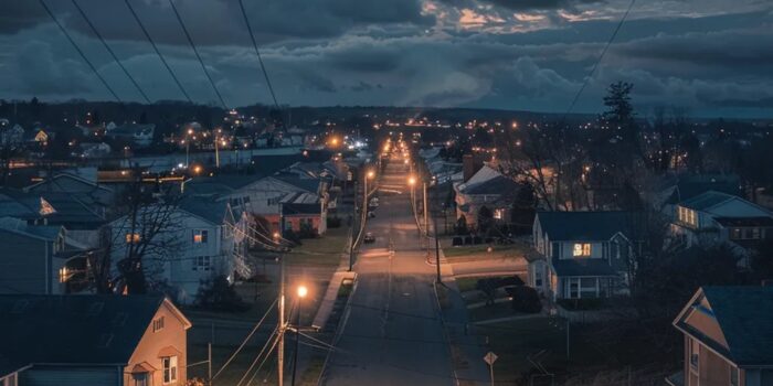 Town with electrical outage showing a few homes still functioning with generators.