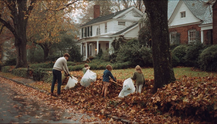 A family in Charlottesville Virginia rakes leaves as part of their fall maintenance plan.