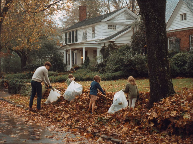 A family in Charlottesville Virginia rakes leaves as part of their fall maintenance plan.